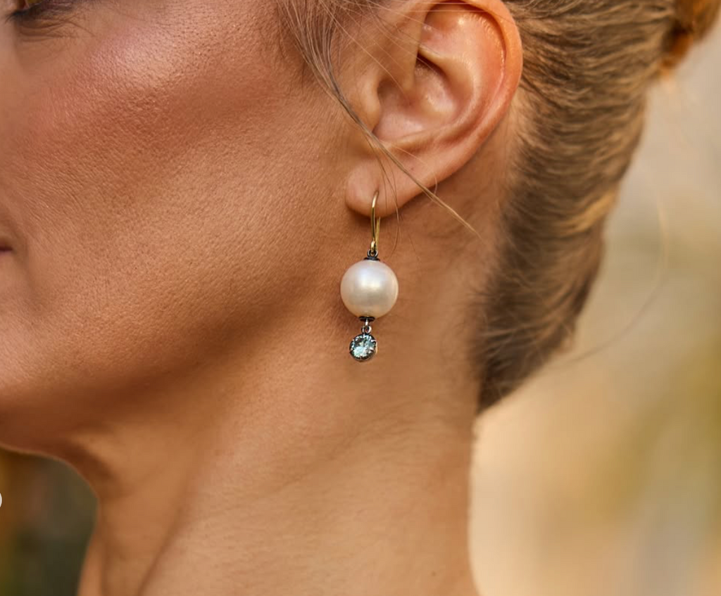 Photograph 2 of Sam Lafford's 18k Yellow Gold Oxi South Sea Pearl & Blue Zircon Earrings. Available on DESIGNYARD.com and in our Contemporary Jewellery Gallery Dublin, Ireland. Free Worldwide Shipping.
