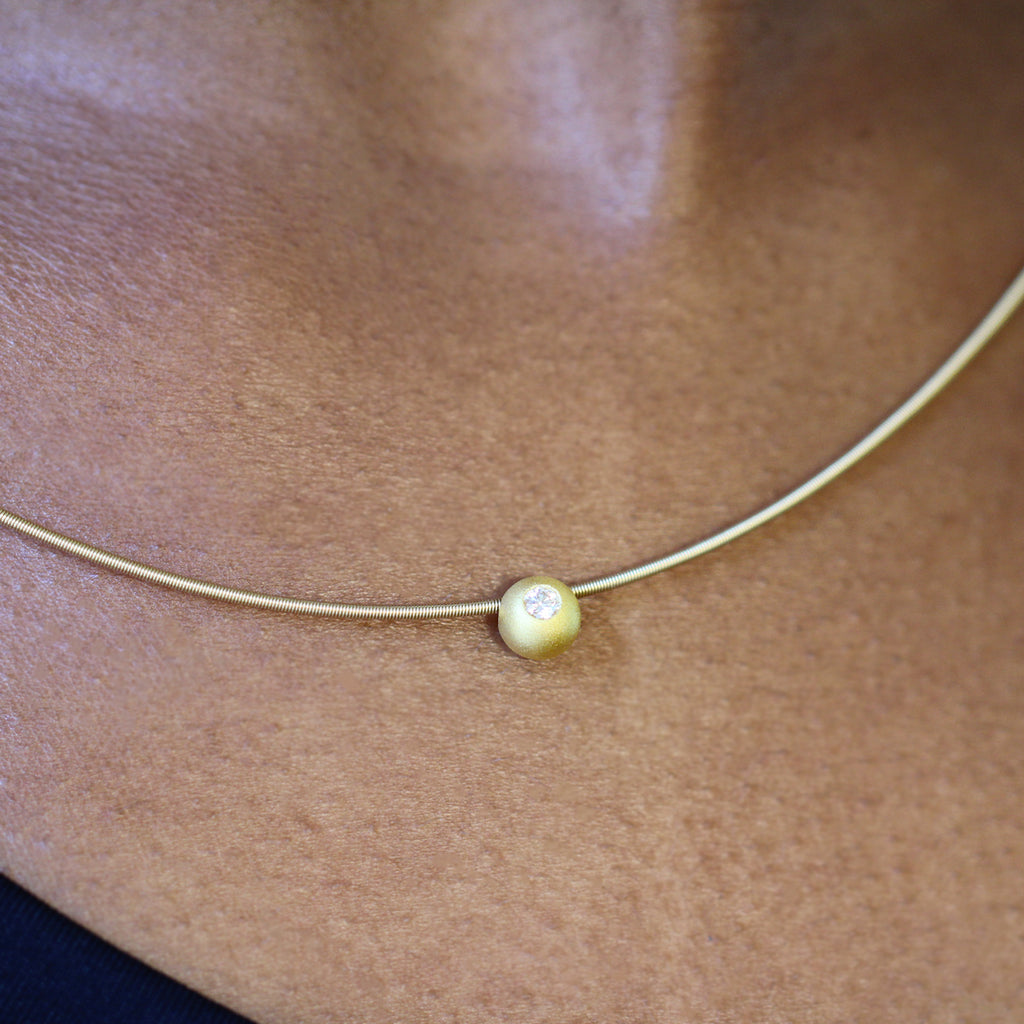Photograph 2 of Niessing's Contemporary 18k Yellow Gold Solaris® Diamond Sphere Necklace. Available on DESIGNYARD.com and in our Jewellery Shop Dublin, Ireland. Free Worldwide Shipping with DHL.