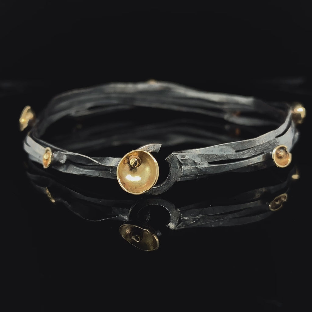Video of Shimara Carlow's Contemporary Oxidised Silver 18k Yellow Gold Acorn Cup Wrap Bracelet. Available on DESIGNYARD.com and in our Jewellery Shop Dublin, Ireland. Free Worldwide Shipping with DHL.