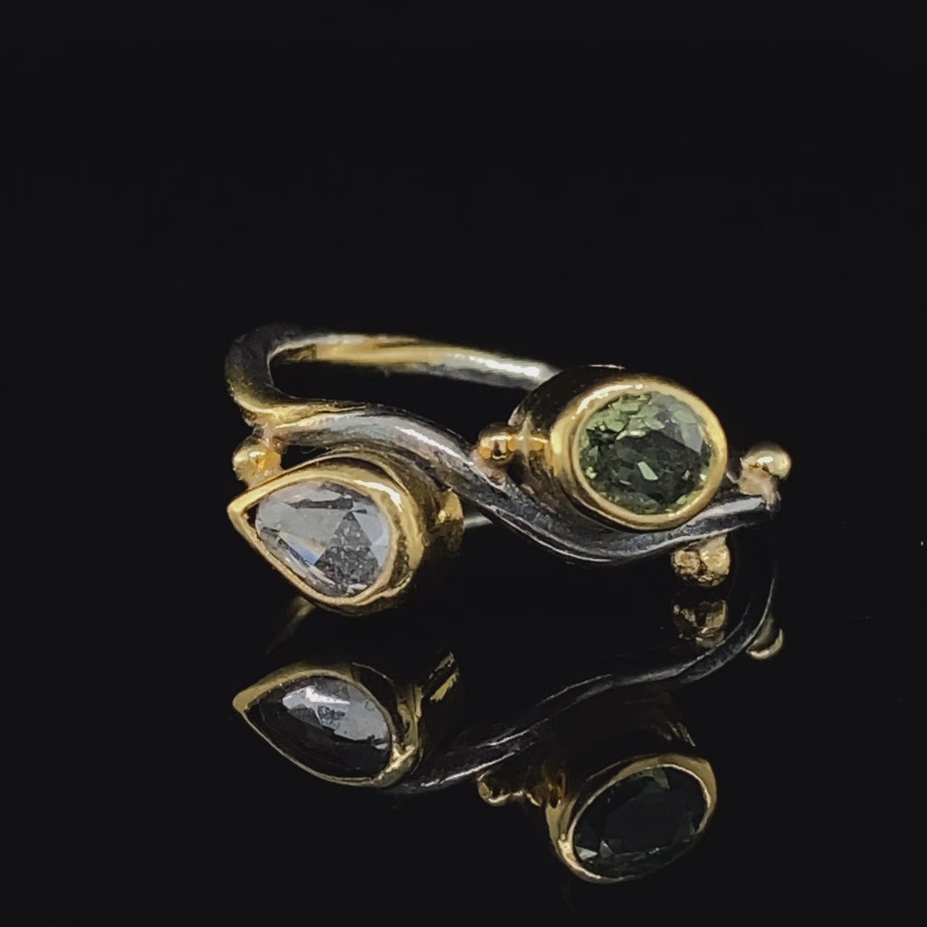 Video of Josephine Bergsøe's contemporary Yellow Gold & Silver Green Sapphire Seafire Engagement Ring. Available on DESIGNYARD.com and in our Jewellery Shop Dublin, Ireland. Free Worldwide Shipping with DHL.