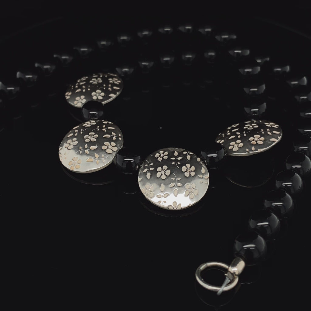 Jane Moore - Sterling Silver Black Glass Embossed Flower Necklace - DESIGNYARD, Dublin Ireland.