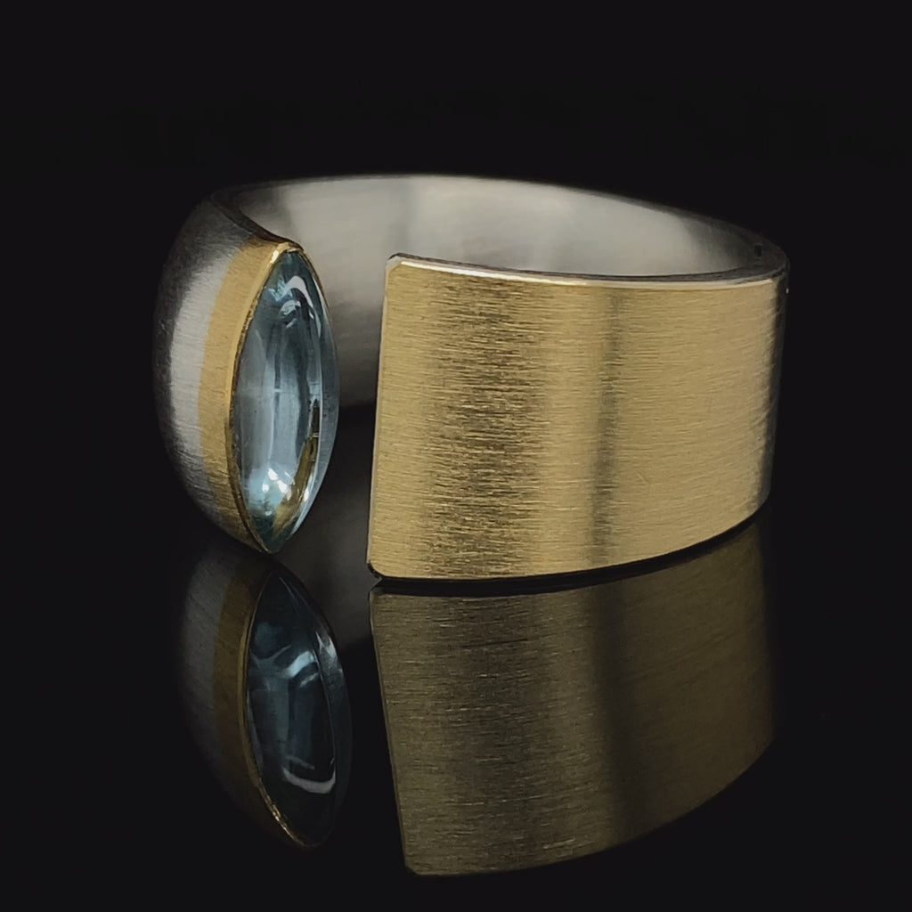 Video of Manu's Contemporary Sterling Silver 22k Yellow Gold Navette Blue Topaz Open Band Ring. Available on DESIGNYARD.com and in our Jewellery Shop Dublin, Ireland.