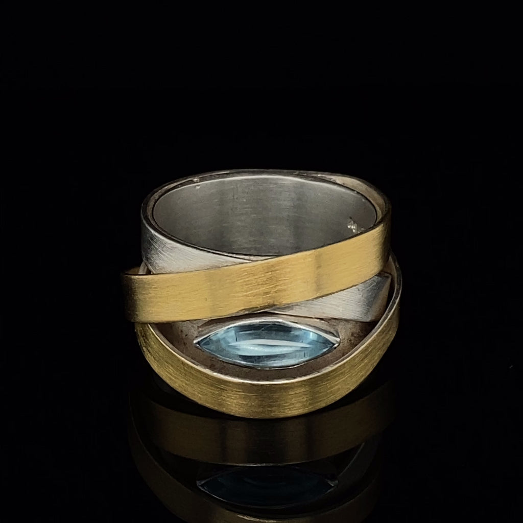 Video of Manu's Contemporary Sterling Silver 22k Yellow Gold Topaz Ribbon Ring. Available on DESIGNYARD.com and in our Jewelry Store Dublin, Ireland.