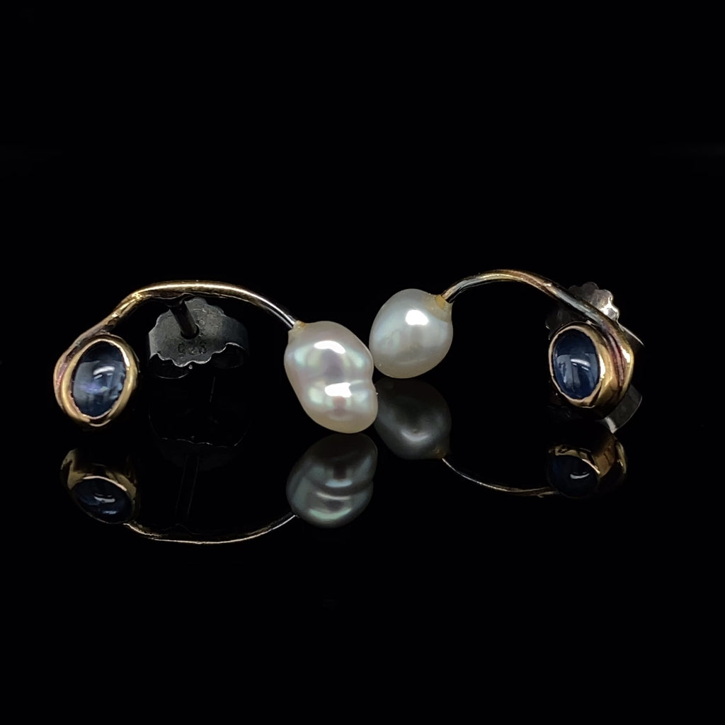 Video of Josephine Bergsøe's Contemporary Silver & Yellow Gold Blue Sapphire Keshi Pearl Seafire Earrings. Available on DESIGNYARD.com and in our Jewellery Shop Dublin, Ireland. Free Worldwide Shipping with DHL.