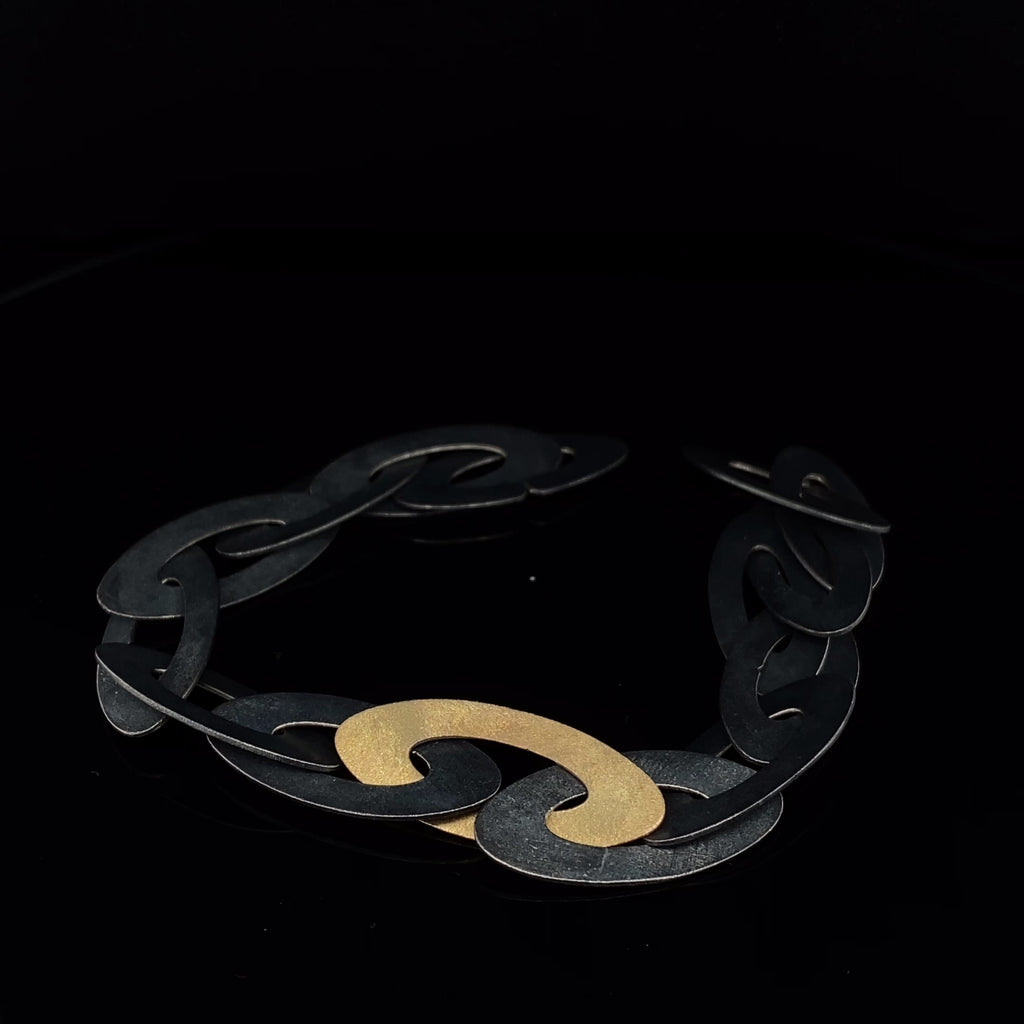 Video of Nicole Van Der Wolf's Contemporary Oxidised Silver 18k Yellow Gold ShipShape Statement Bracelet. Available on DESIGNYARD.com and in our Jewellery Shop Dublin, Ireland. Free Worldwide Shipping with DHL.