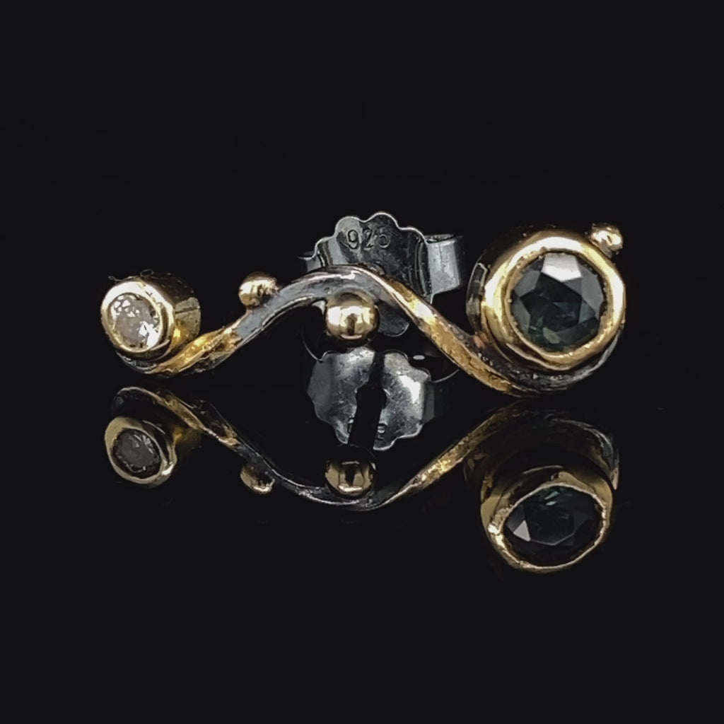 Video of Josephine Bergsøe's Contemporary Silver & Yellow Gold Seafire Sapphire Single Earring. Available on DESIGNYARD.com and in our Jewellery Shop Dublin, Ireland. Free Worldwide Shipping with DHL.