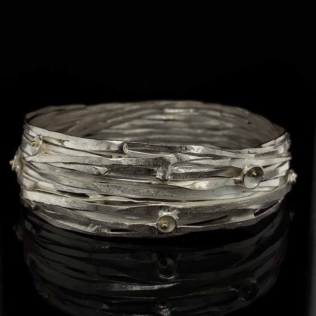 Video of Shimara Carlow's Contemporary Sterling Silver 18k Yellow Gold Wrap Bangle. Available on DESIGNYARD.com and in our Jewellery Shop Dublin, Ireland. Free Worldwide Shipping with DHL.