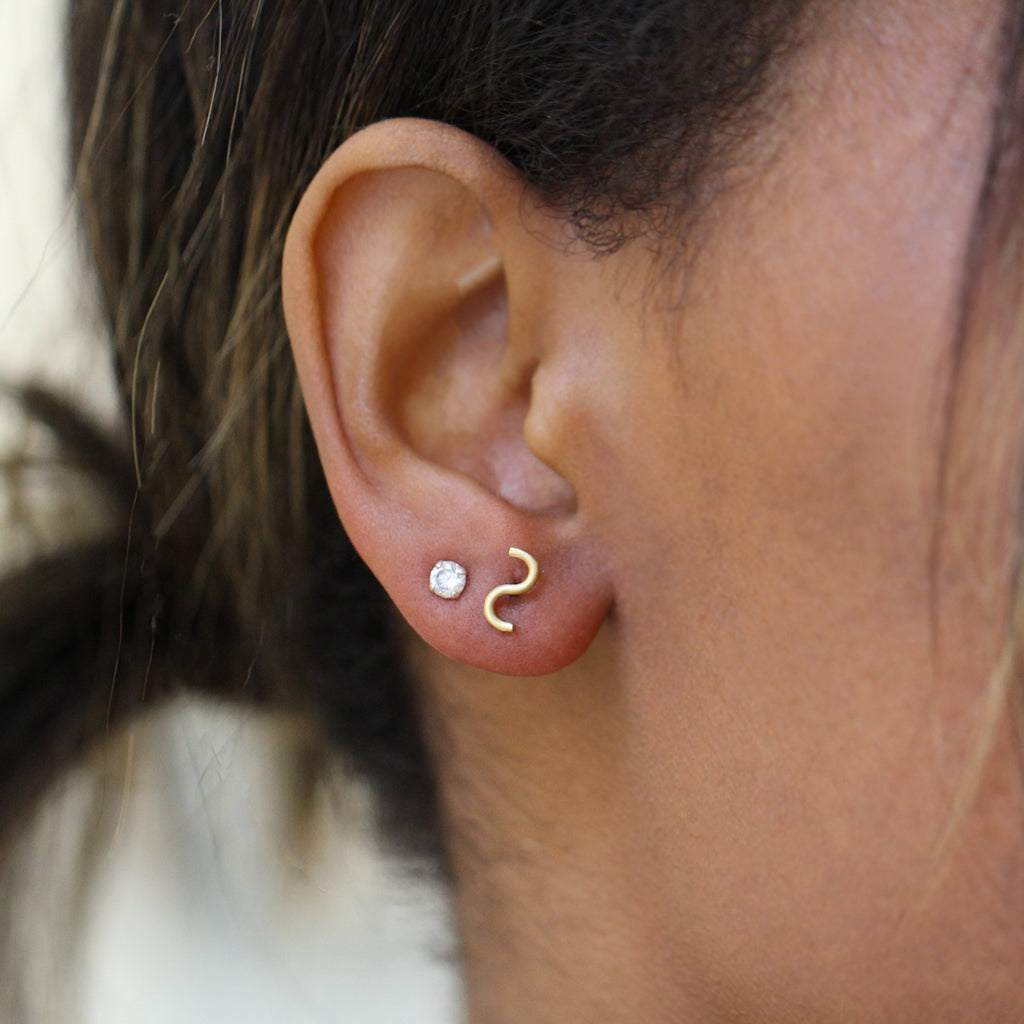 Photograph 2 of Shimell & Madden's Contemporary 18k Yellow Gold S Stud Dainty Earrings. Available on DESIGNYARD.com and in our Jewellery Shop Dublin, Ireland. Free Worldwide Shipping with DHL.