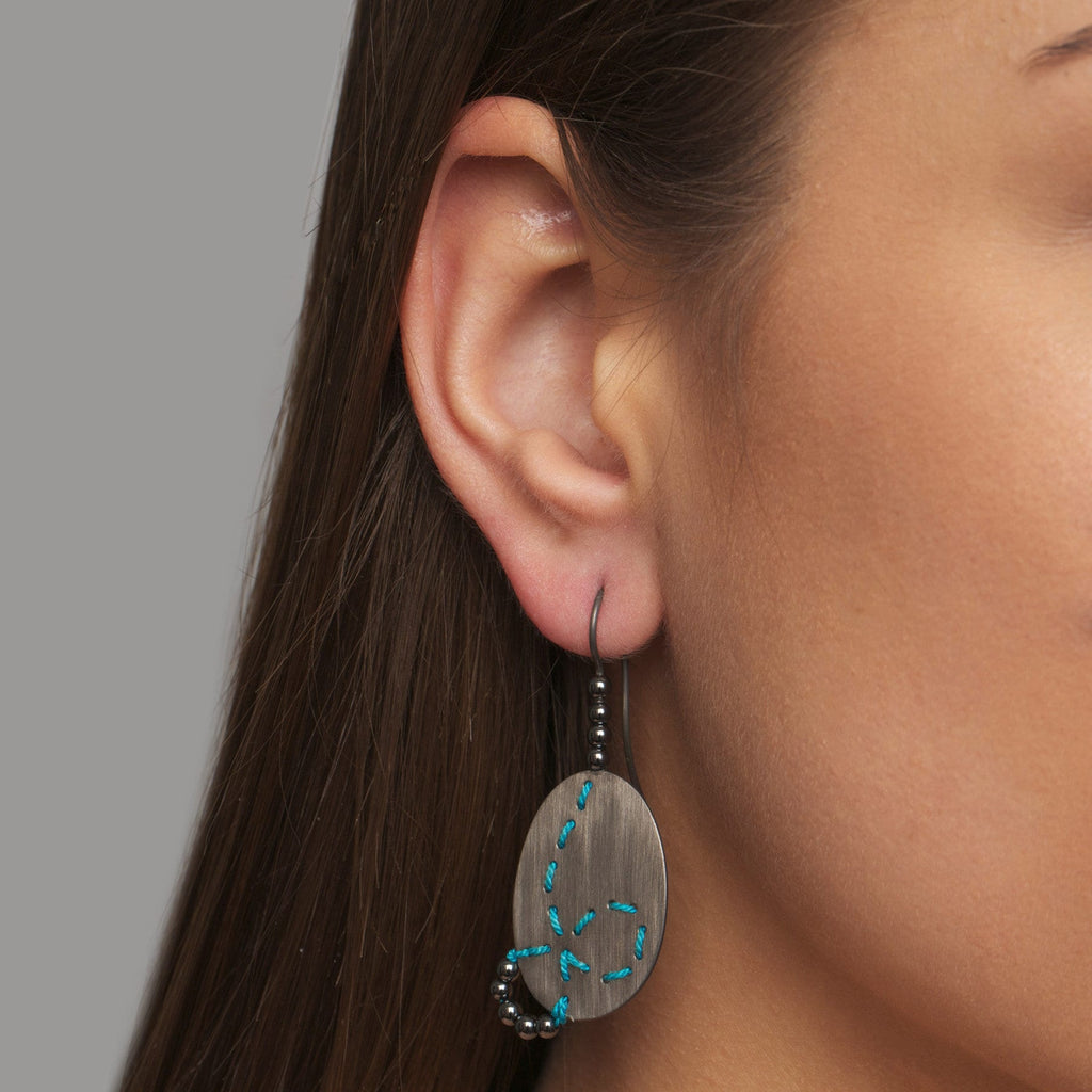 Photograph 2 of Brigitte Adolph's Contemporary Oxidized Silver Turquoise Silk Hematite Loop Red Dot Award Winning Earrings. Available on DESIGNYARD.com #1 for Contemporary Jewellery Dublin, Ireland. Free Worldwide Shipping with DHL.