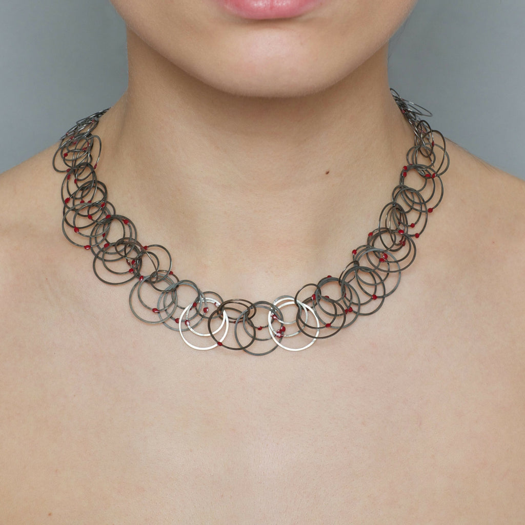 Photograph 2 of Erik Urbschat's Contemporary Iron Red Dot 3 Necklace. Available on DESIGNYARD.com and in our Jewellery Shop Dublin, Ireland.