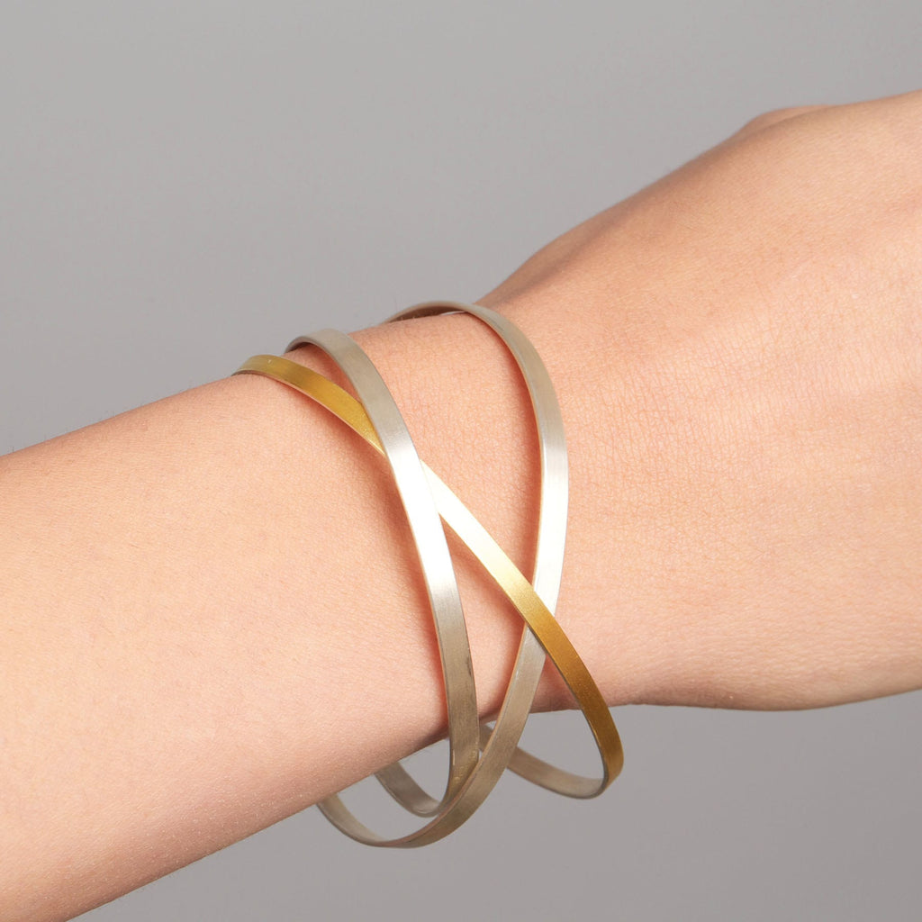 Photograph 2 of Manu's Contemporary Sterling Silver 22k Yellow Gold Bi-Metal Dancing Ribbons Bracelet. Available on DESIGNYARD.com and in our Jewelry Store Dublin, Ireland. Free Worldwide Shipping with DHL
