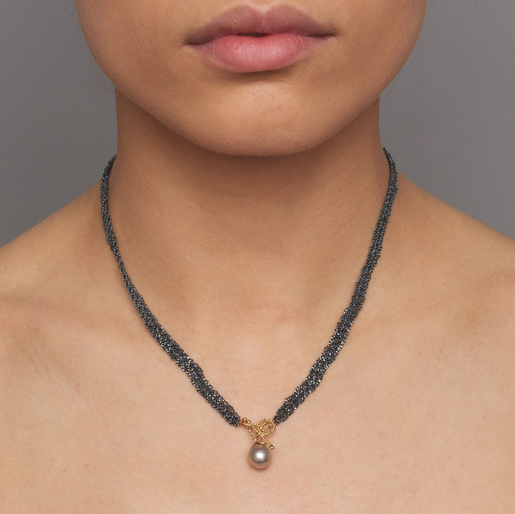 Photograph 2 of Myriam Oude Vrielink's Oxidized Silver 14k Yellow Gold Tahiti Pearl Single Ribbon Necklace. Available on DESIGNYARD.com and in our Contemporary Jewellery Shop Dublin, Ireland. #1 for Contemporary Jewellery.