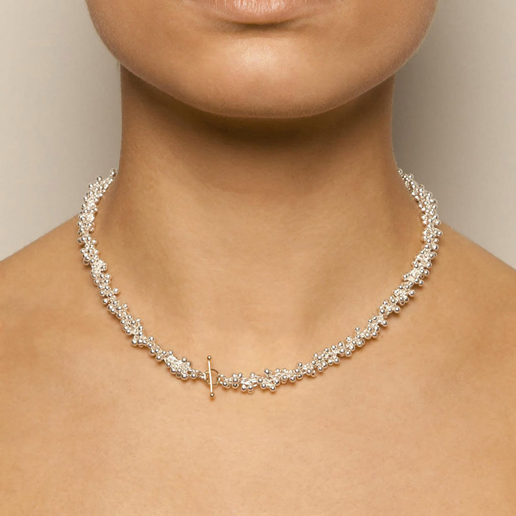 Photograph 3 Neeltje Huddleston Slater's 14k Yellow Gold T-Bar Clasp Double Silver Necklace. Available on DESIGNYARD.com and in Contemporary Jewellery Shop Dublin, Ireland. #1 for Contemporary Jewellery.