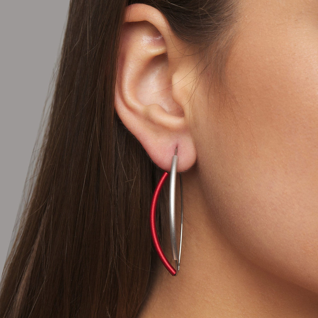 Photograph 2 of Ursula Muller's Contemporary Red Aluminium Hoop Statement Earrings. Available on DESIGNYARD.com and in our Jewellery Shop Dublin, Ireland. Worldwide Shipping with DHL.