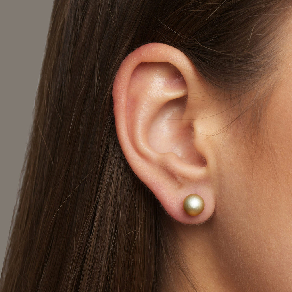 Photograph 2 of Ursula Muller's Contemporary Gold Ball Steel Aluminium Stud Earrings. Available on DESIGNYARD.com and in our Jewellery Shop Dublin, Ireland. Worldwide Shipping with DHL.