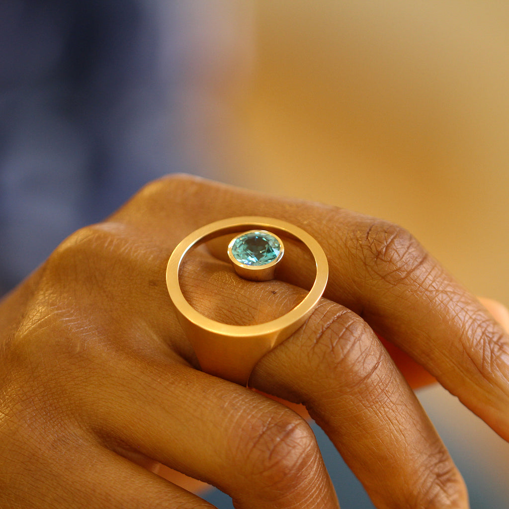 Photograph 2 of Angela Hubel's Contemporary 18k Rose Gold Treasure Island Blue Zircon Statement Ring. Available on DESIGNYARD.com No. 1 for Contemporary Jewellery Dublin, Ireland. Free Worldwide Shipping with DHL.
