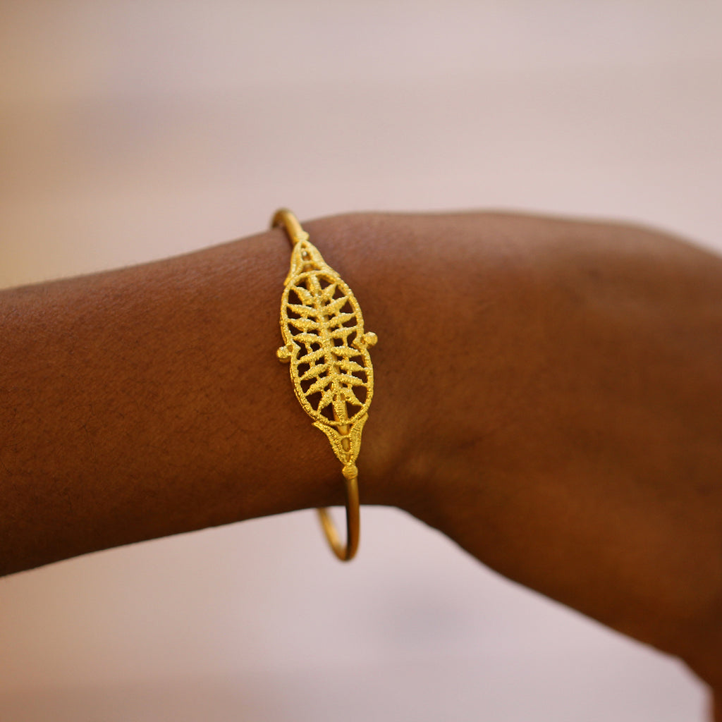 Photograph 2 of Brigitte Adolph's 18k Yellow Gold Adrienne Luxury Statement Bangle. Available on DESIGNYARD.com No 1 for Contemporary Jewellery Dublin, Ireland. Free Worldwide Shipping with DHL.