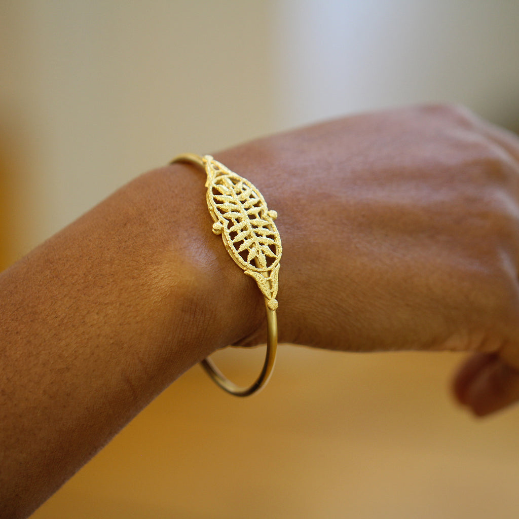 Photograph 2 of Brigitte Adolph's 18k Yellow Gold Adrienne Luxury Statement Bangle. Available on DESIGNYARD.com No 1 for Contemporary Jewellery Dublin, Ireland. Free Worldwide Shipping with DHL.