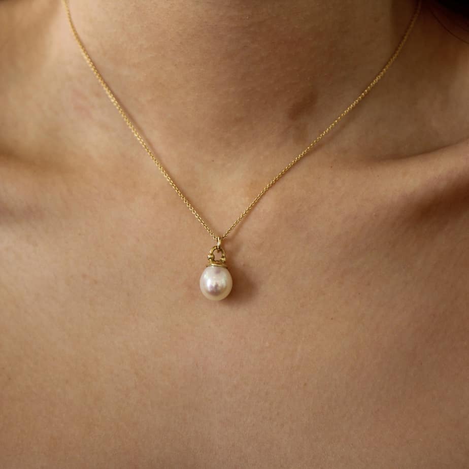 Photograph 2 of Cassie McCann's 18k Yellow Gold Pearl Athena dainty Pendant. Available on DESIGNYARD.com and in our Jewellery Shop Dublin, Ireland.