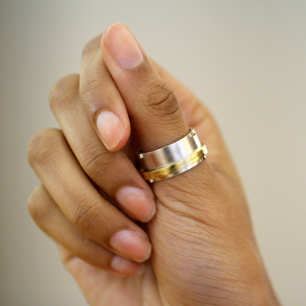 Photograph 2 of Inga Reed's Contemporary Silver 18k Yellow Gold Rivet Spinner Statement Ring. Available on DESIGNYARD.com and in our Jewellery Shop Dublin, Ireland.