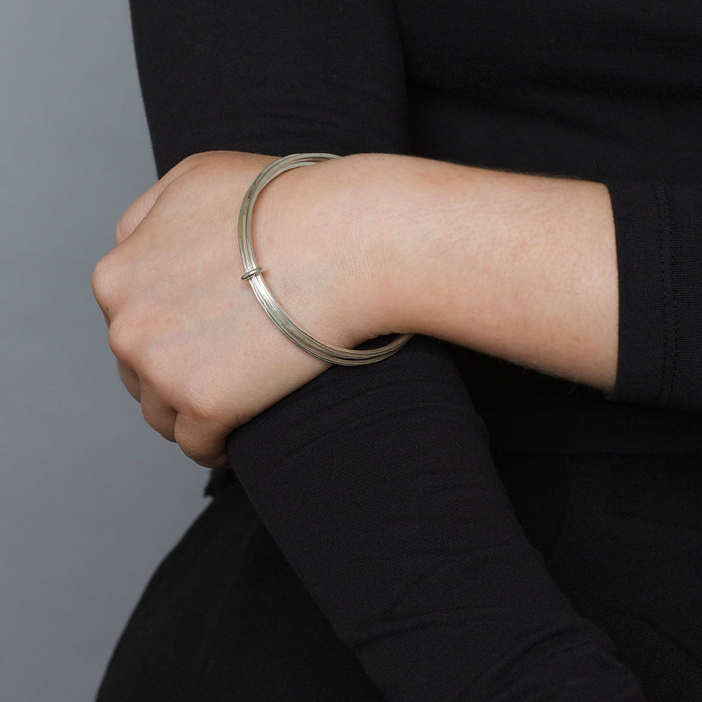 Photograph 2 of Latham & Neve's Contemporary Sterling Silver Ripple Bangle. Available on DESIGNYARD.com and in our Jewellery Shop Dublin, Ireland. Worldwide Shipping with DHL.