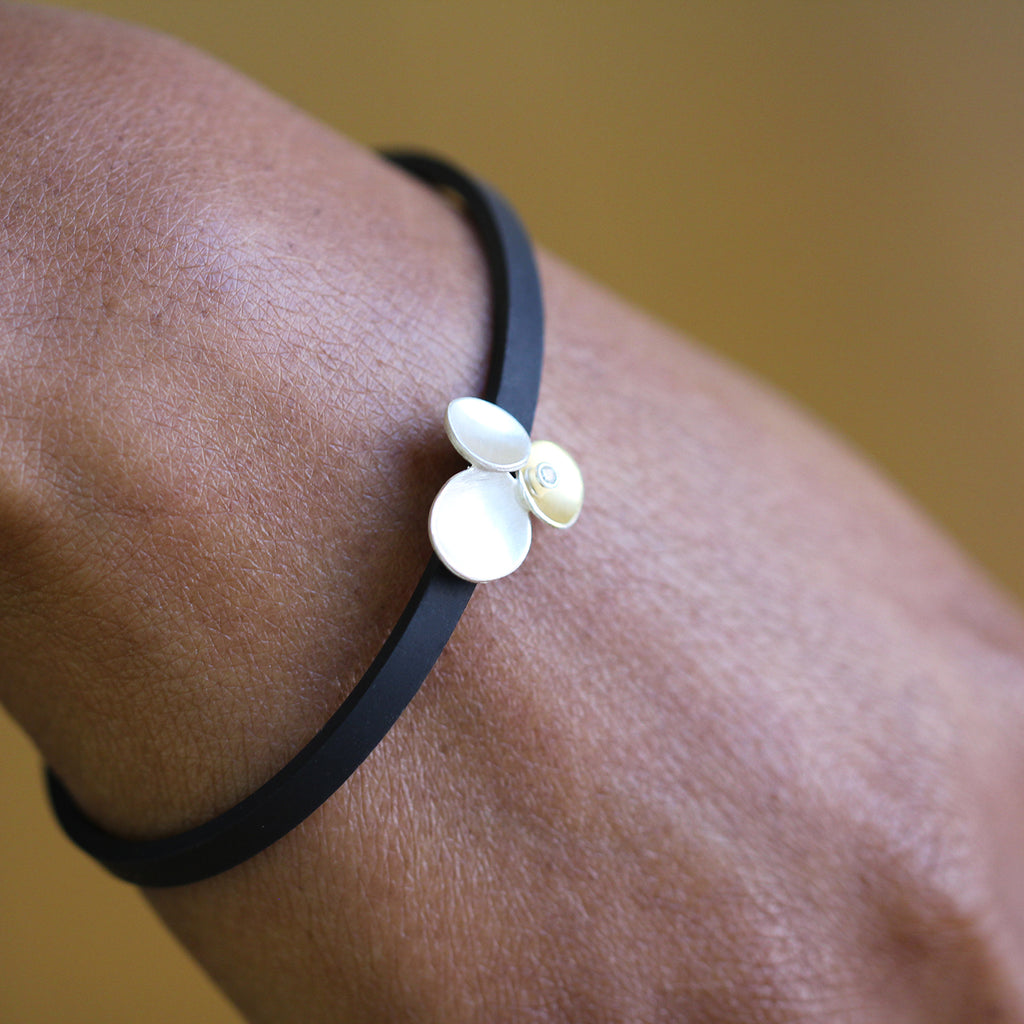 Photograph 4 of Manu's Contemporary Sterling Silver & 22k Yellow Gold Trillium Diamond Rubber Bracelet. Available on DESIGNYARD.com and in our Jewellery Shop Dublin, Ireland. Free Worldwide Shipping with DHL.
