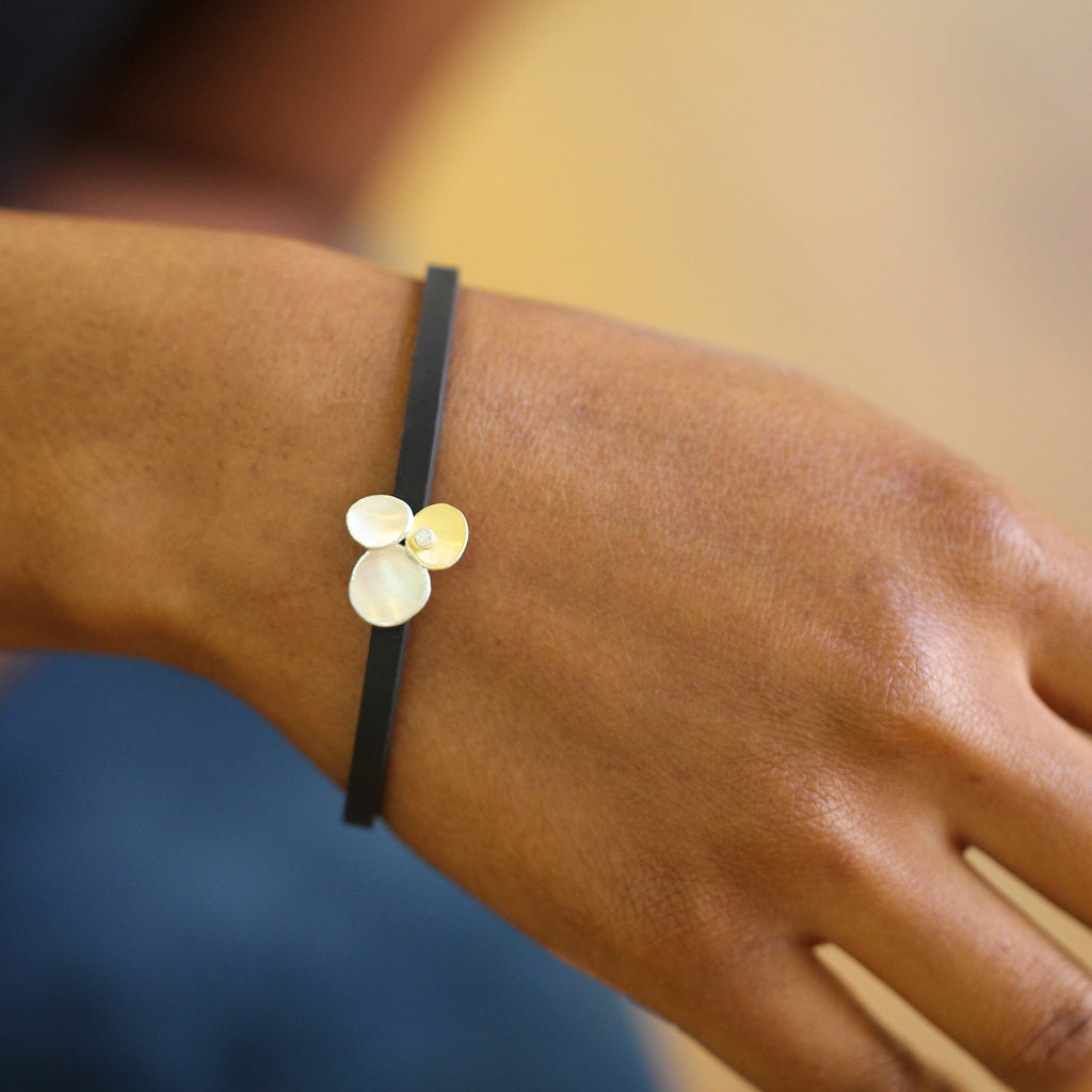 Photograph 3 of Manu's Contemporary Sterling Silver & 22k Yellow Gold Trillium Diamond Rubber Bracelet. Available on DESIGNYARD.com and in our Jewellery Shop Dublin, Ireland. Free Worldwide Shipping with DHL.
