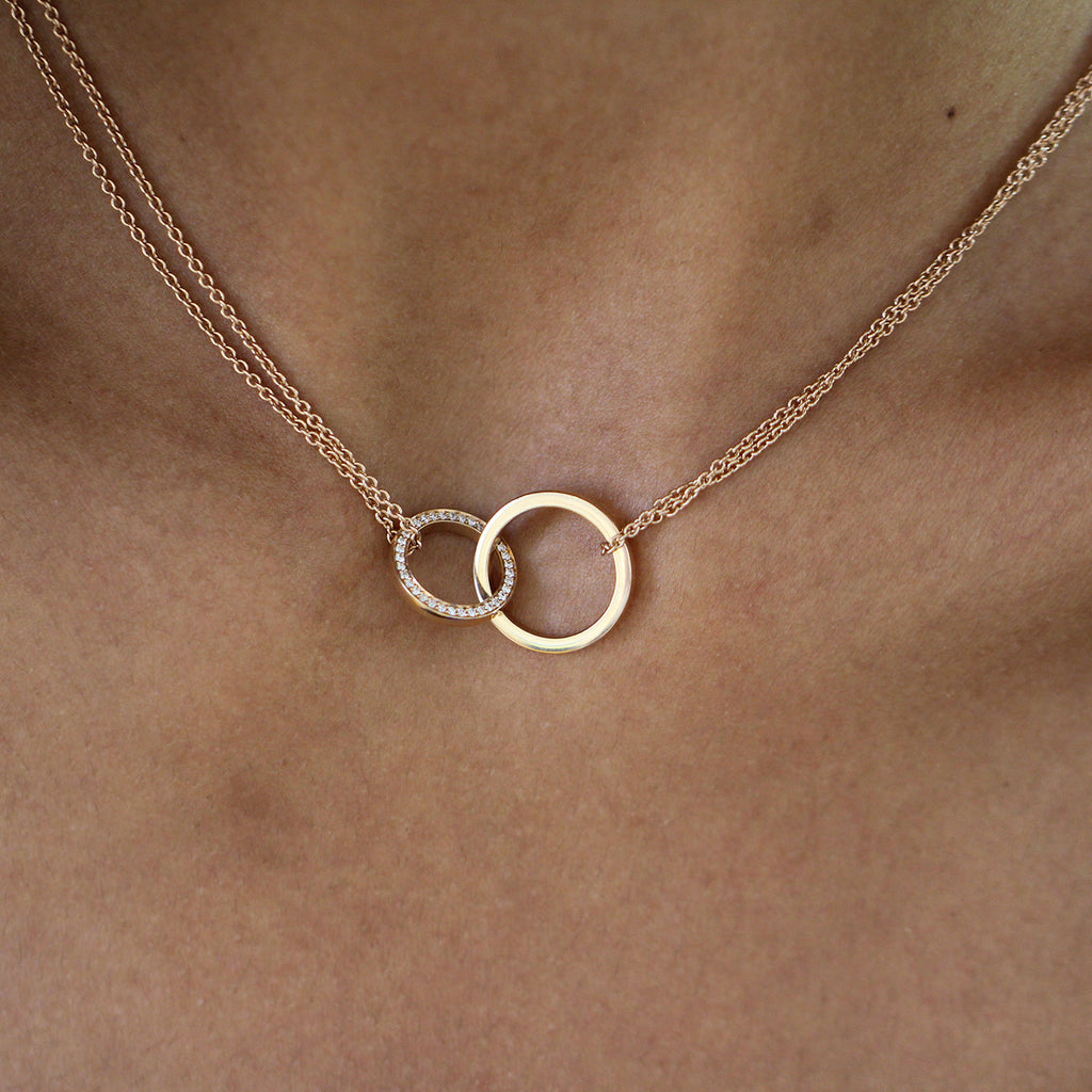 Photograph 2 of Meister's Contemporary 18k Rose Gold Two Rings Interlocking Diamond Necklace. Available on DESIGNYARD.com and in our Jewellery Shop Dublin, Ireland. Free Worldwide Shipping with DHL.