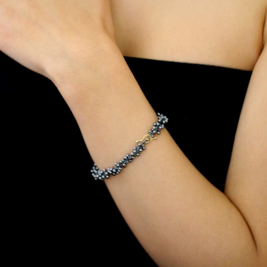 Photograph 3 of Neeltje Huddleston Slater's Contemporary Fine Oxidised Silver 14k Yellow Gold Double Beaded Bracelet. Available on DESIGNYARD.com and in our Jewellery Shop Dublin, Ireland. Free Worldwide Shipping with DHL.