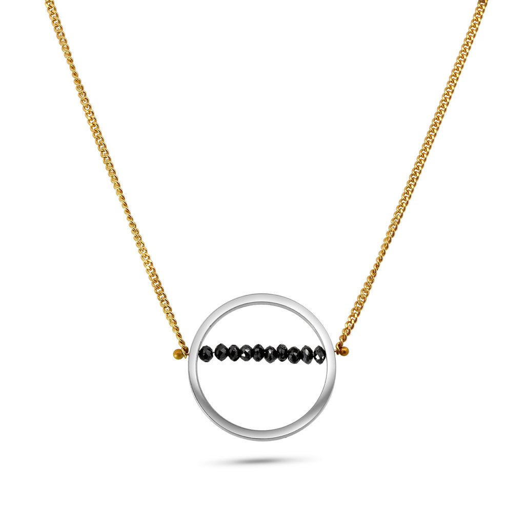 Photograph 1 of Nicole Van Der Wolf's 18k Yellow Gold Large Round Silver Black Diamond Pendant. Available on  DESIGNYARD.com and in our Jewellery Shop Dublin, Ireland.