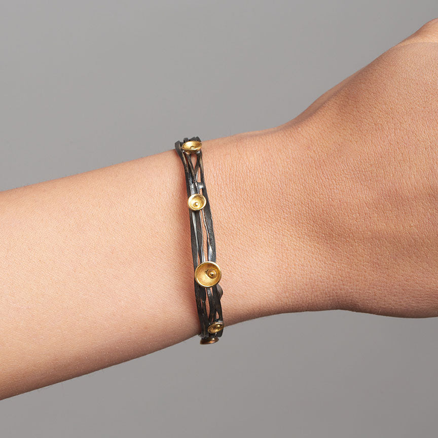 Photograph 2 of Shimara Carlow's Contemporary Oxidised Silver 18k Yellow Gold Acorn Cup Wrap Bracelet. Available on DESIGNYARD.com and in our Jewellery Shop Dublin, Ireland. Free Worldwide Shipping with DHL.