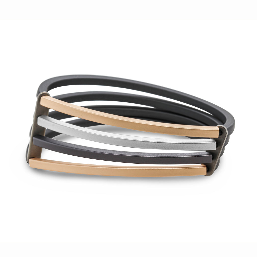 Photograph 1 of Ursula Muller's Contemporary Grey Rubber Champagne 4 Strand Structured Aluminium Bracelet. Available on DESIGNYARD.com and in our Jewellery Shop Dublin, Ireland.