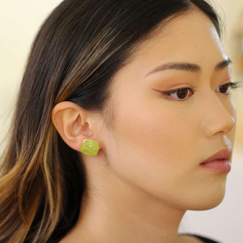 Photograph 2 of Ursula Muller's Contemporary Lemon Aluminium Embossed Cushion Earrings. Available on DESIGNYARD.com and in our Jewellery Shop Dublin, Ireland. Worldwide Shipping.