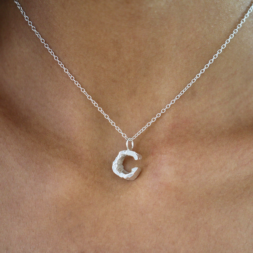 Photograph 2 of Xavier Lafford's Contemporary Sterling Silver Chunky C Pendant. Available on DESIGNYARD.com and in our Jewellery Shop Dublin Ireland.